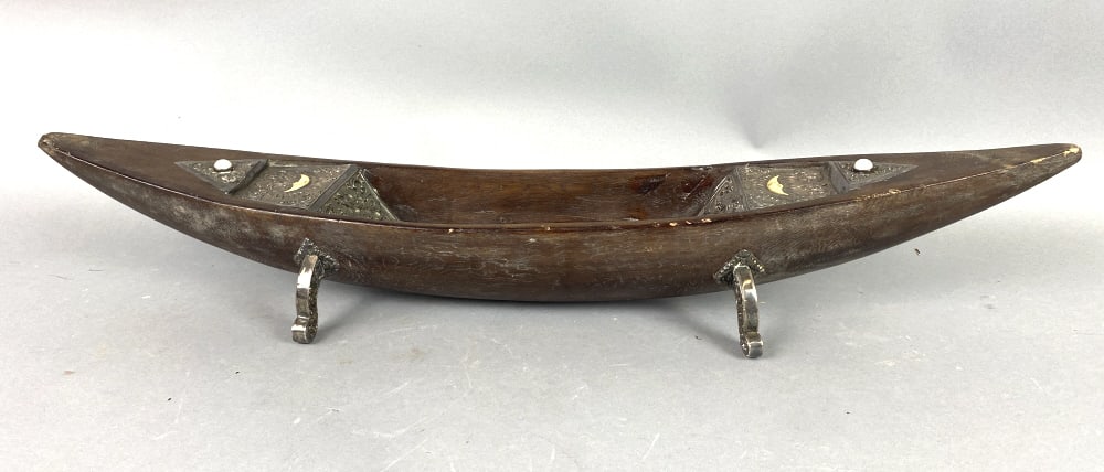 Agarwood Boat with Silver Mounts: Agarwood Boat with Silver Mounts and decorated inside with silver, bone moon and pearl inset. 5"h x 27 7/8"w x 5"d Condition: Some scratches, scuffs.
