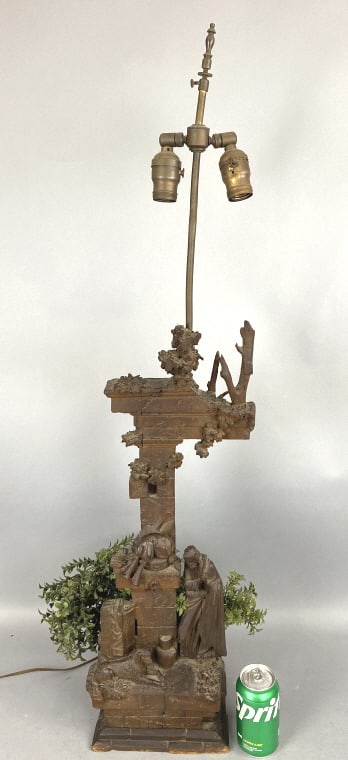 Carved Wood Sculpture Lamp of Ruins: Carved Wood Sculpture Lamp of Ruins with man & a dog. Overall: 40 1/4"h x 9"w x 7 1/2"d Condition: Scratches, scuffs, checks in wood, socket needs replacing.