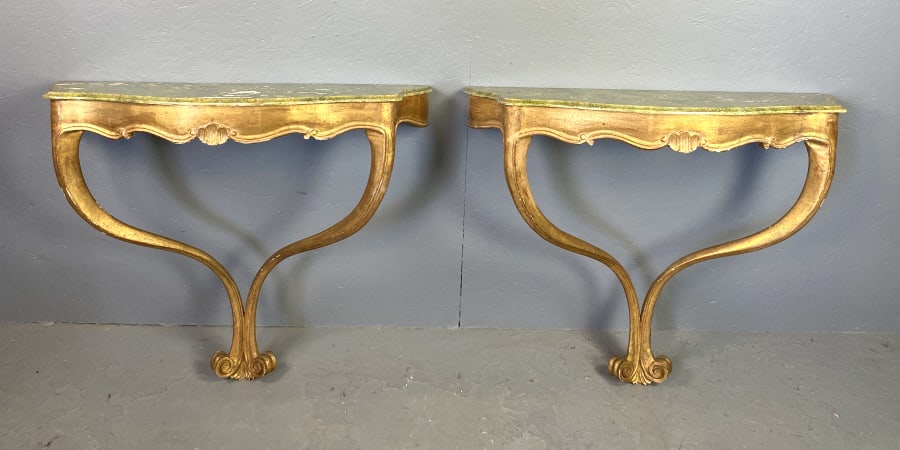 Pair of Florentine Style Giltwood Consoles: Pair of Florentine Style Giltwood Consoles. Faux marble tops. 31 1/2"h x 39"w x 14"d Condition: Some loss to paint on top, minor loss of gilt.