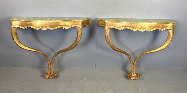 Pair of Florentine Style Giltwood Consoles: Pair of Florentine Style Giltwood Consoles. Faux marble tops. 31 1/2"h x 39"w x 14"d Condition: Some loss to paint on top, minor loss of gilt.