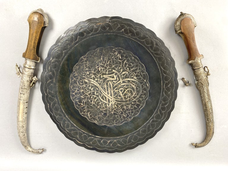 2 Moroccan Silver Daggers & Etched Copper Platter: 2 Moroccan Silver Daggers & Etched Copper Platter. Platter: 14 3/4"diam. Condition: Needs cleaning, broken side piece on 1 knife.