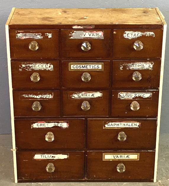 Wood Apothecary Cabinet: Wood Apothecary Cabinet. 29"h x 24 1/2"w x 10 1/2"d Condition: Overall wear, some loss of labels, wear to labels.