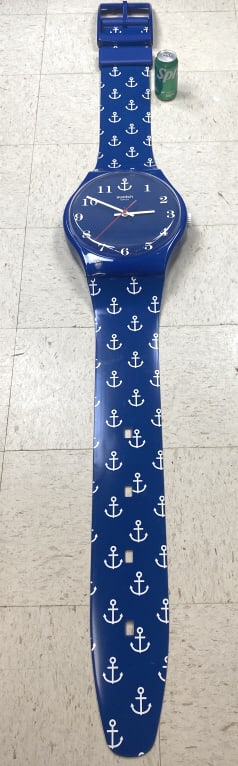 Blue Swatch Wall Clock: Blue Swatch Wall Clock. 83"long x 12 1/2"diam. Condition: Scratches, scuffs.