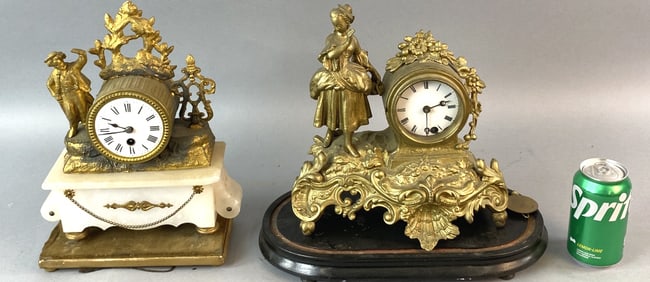 Two Figural White Metal Clocks