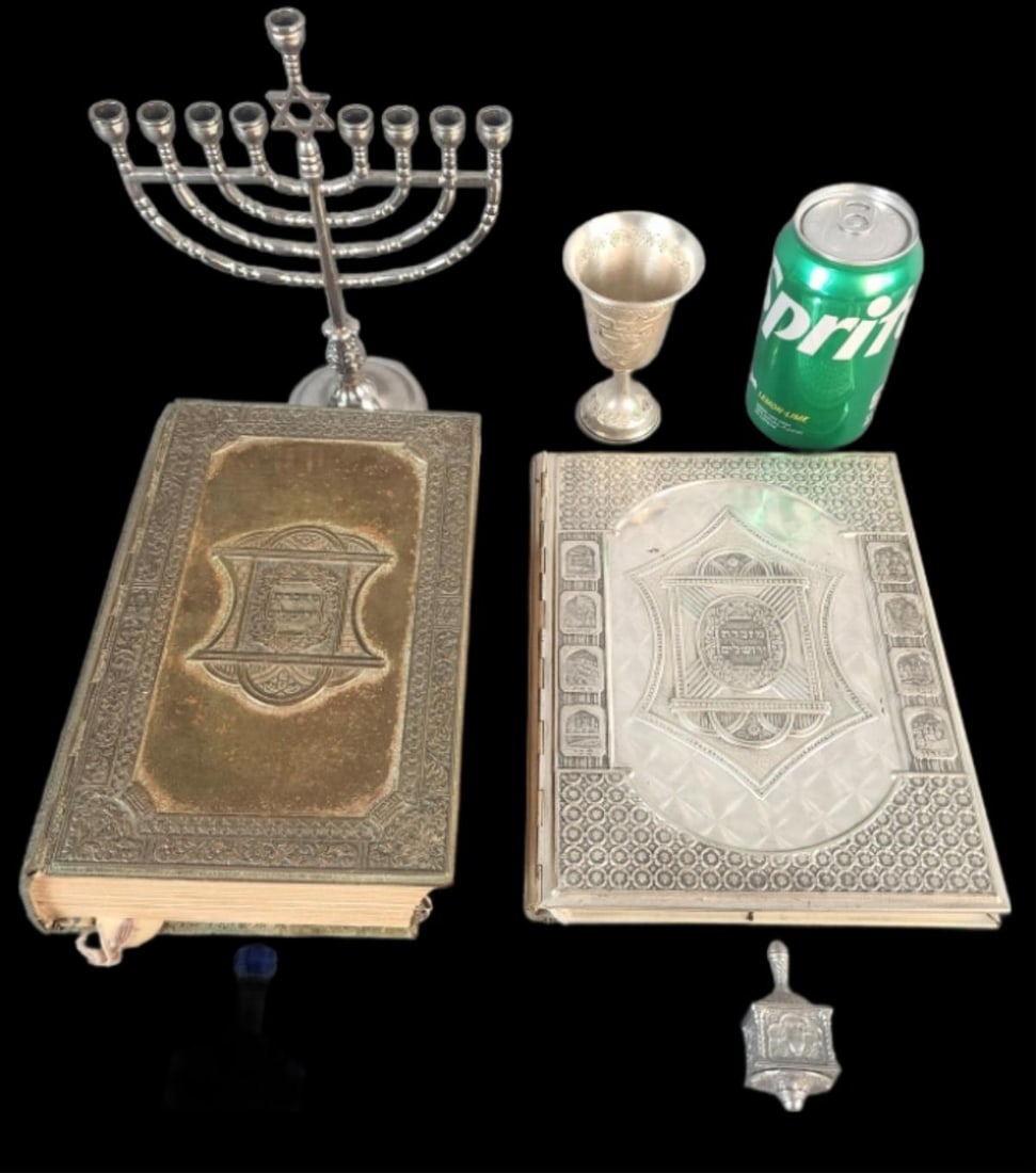 Grouping of Judaic Articles: Grouping of Judaic Articles. Comprising of: Vintage Arthur Szyk Haggadah silver cased] book The Illustrated Jerusalem Bible, English translation 2 dreidels, 1 silver & 1 crystal 800 silver Kiddush cup