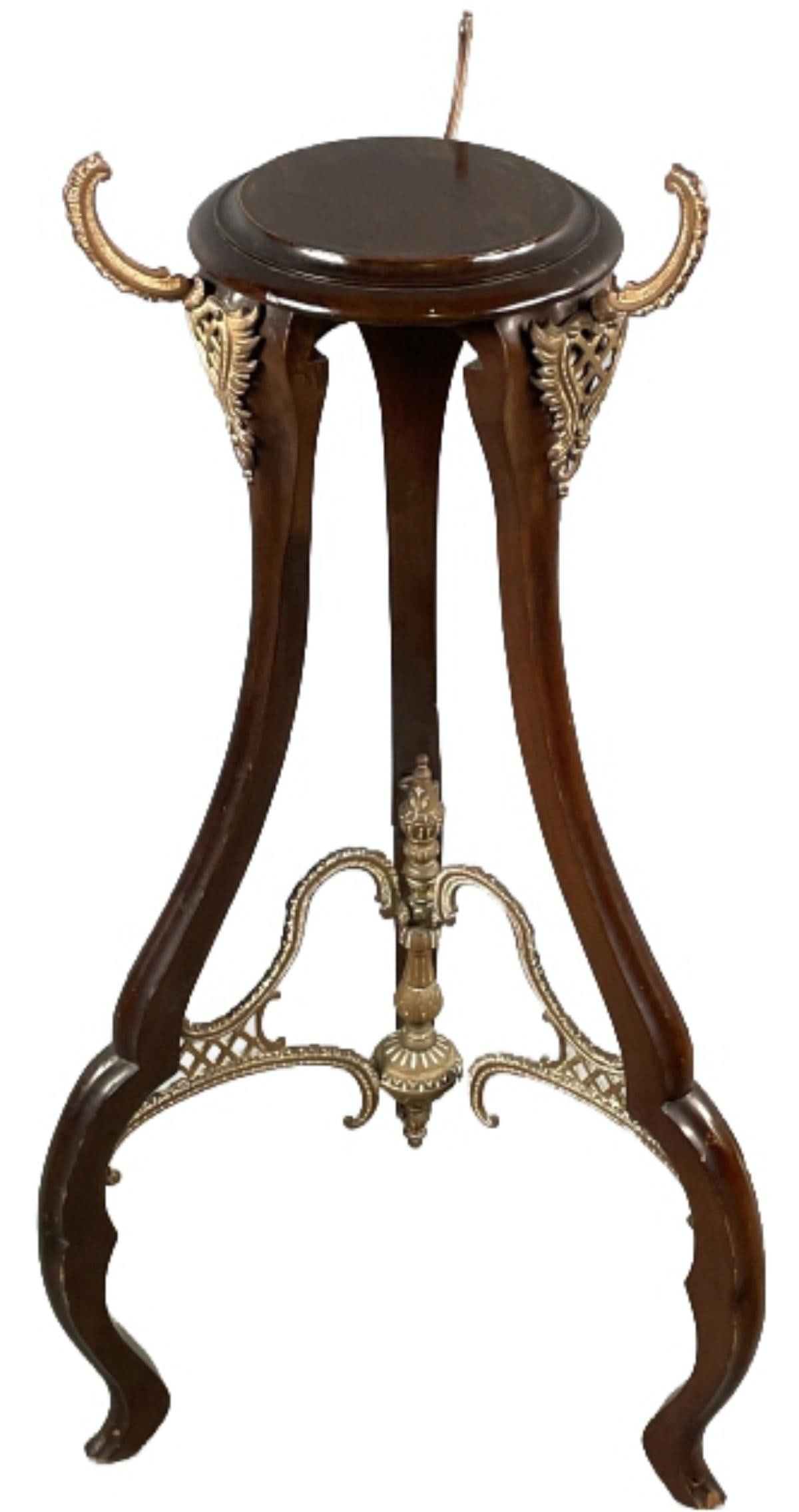 Victorian Mahogany and Brass Plant Stand: Victorian Mahogany and Brass Plant Stand. 55"h x 19" diam. Condition, Some scratches and scuffs, chipped wood to legs.
