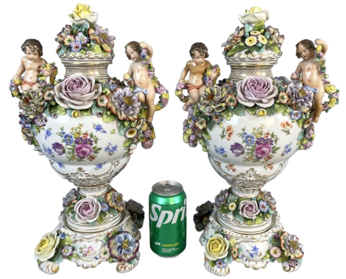 Pair of Sitzendorf Ornate Covered Urns: Pair of Sitzendorf Ornate Covered Urns. 17"h x 10 1/2"w x 7"d Condition: Small chips on a few flowers.