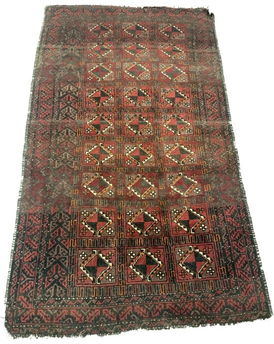 Persian Baluch Red Wool Rug: Persian Baluch wool rug. Red with geometric pattern. Label on underside, illegible. Measures 5?10" l x 3?4"w. Condition: Overall wear, loss of fringe and side binding, needs cleaning.