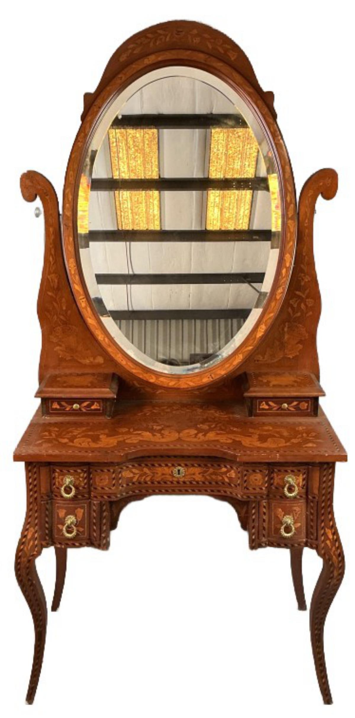 Dutch Marquetry Vanity: Dutch marquetry vanity with oval mirror. Measures 72.5"h x 33.5"w x 18.5?d. Condition: Some scratches and scuffing, nicks to wood. Missing one piece of mirror hardware.