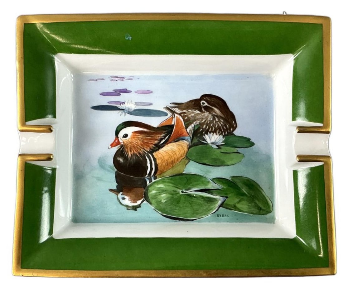 Hermes Limoges Porcelain Duck Ashtray: Vintage Hermes Limoges porcelain ashtray. Hand painted, signed Rybal. Marked Hermes, made in France. Swimming ducks. Measures 7.25"h x 6.25?w x 1.25?h. Condition: Good, some scratches.