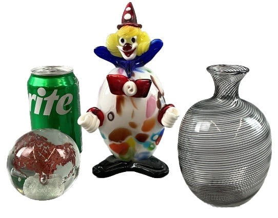 Grouping of Murano Art Glass & Other: Grouping of art glass. Comprised of: 1 Murano clear and black Filigrana vase. 1 Murano confetti clown figurine. 1 paperweight with red inclusions. Tallest piece measures 8"h. Condition: Good, some scr