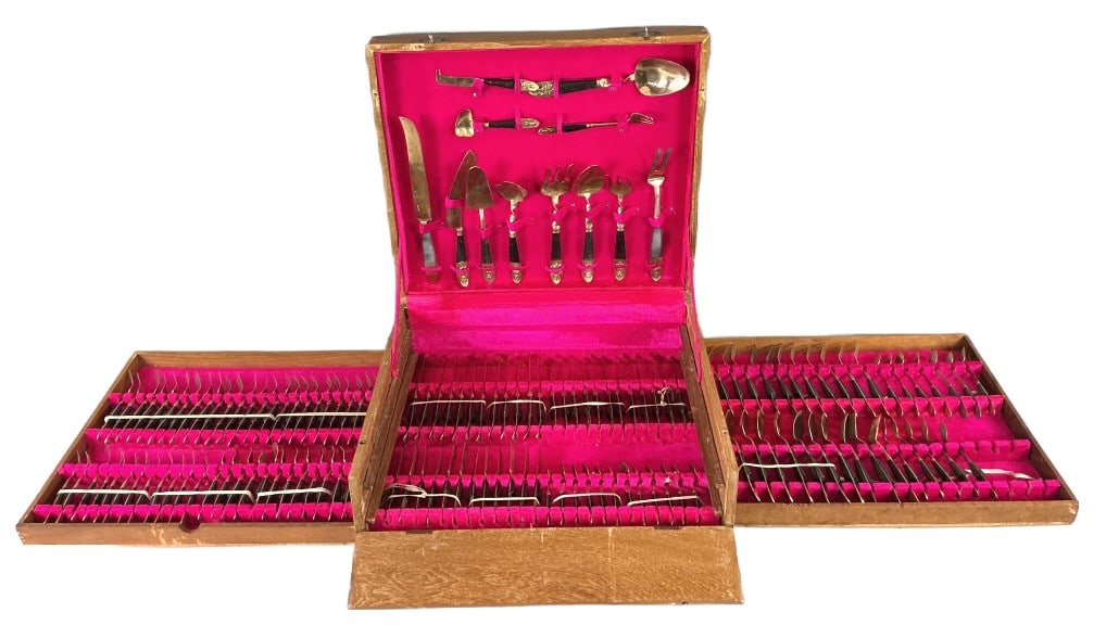 Vintage Thai Brass Flatware Set: Vintage Thai brass flatware set with storage box. Comprised of: 12 pieces serving utensils. 36 knives. 46 spoons. 47 forks. Largest piece measures 12"l. Condition: Needs polishing. Some scratches, ben