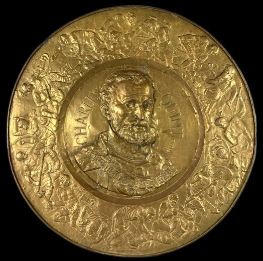 Large Emperor Charles V Brass Plaque: Large Emperor Charles V circular repousse brass plaque. Measures 38.5"dia. Condition: Some patina, bending, scratches.