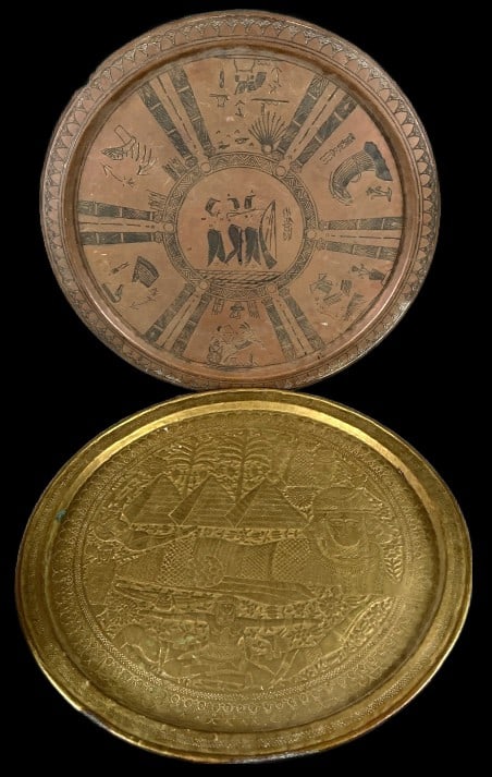 2 Egyptian Revival Style Copper & Brass Plaques: 2 Egyptian Revival style copper and brass plaques. Larger measures 27.75"dia. Condition: Needs polishing. Some scratches and bent metal.