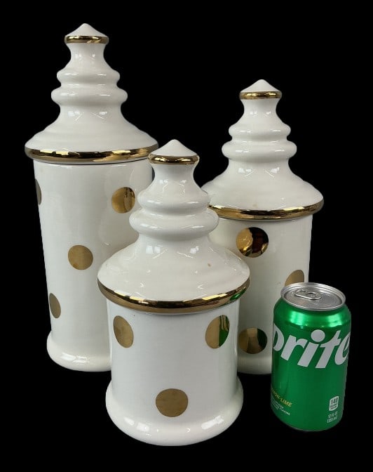 Set of 3 Laurie Gates Ceramic Cookie Jars: Set of 3 Laurie Gates ceramic cookie jars. White with gilt polka dot. Largest measures 14.5"h x 5.25"dia. Condition: Some scratches.