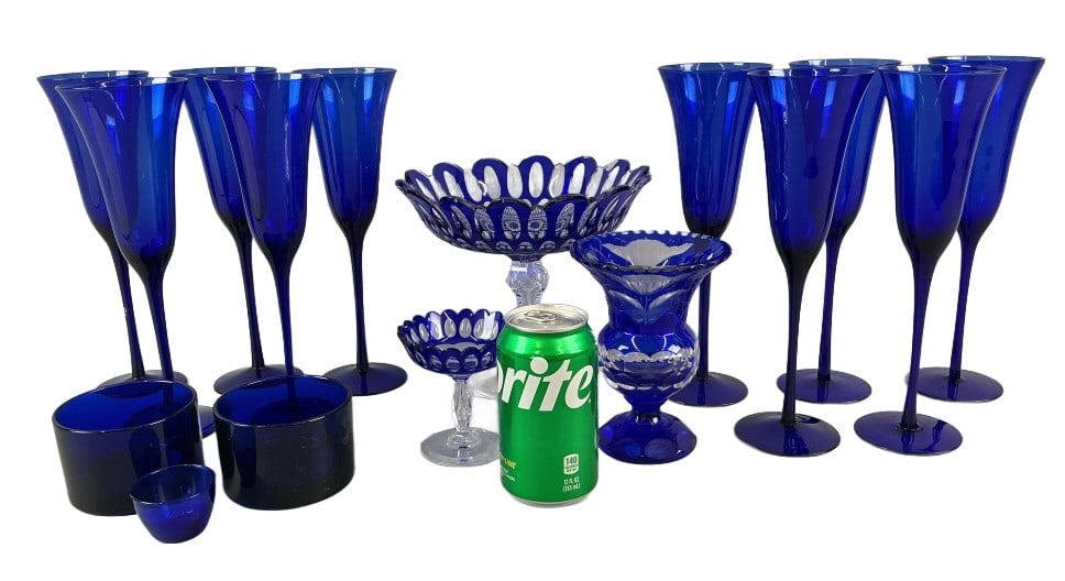 Grouping of Cobalt Crystal & Glass Articles: Grouping of cobalt blue crystal and glass articles. Comprised of: 2 cobalt to clear cut crystal compotes. 1 cobalt to clear cut crystal vase. 3 cobalt glass bowls. 10 cobalt glass flute glasses. Large