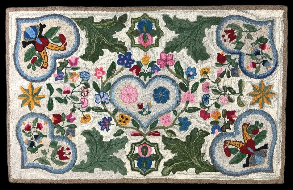 American Folk Art Bird & Heart Hooked Rug: American folk art hand hooked rug mounted on fabric and board. Bird of paradise, heart, and floral pattern. Measures 29.5"h x 46.25"w (mounted). Condition: Discoloration and rubbing.