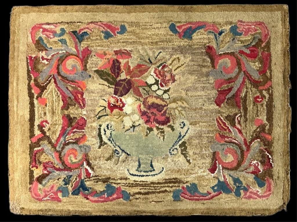 Antique American Folk Art Hand Hooked Rug: Antique American folk art hand hooked rug mounted on fabric and board. Central floral urn design. Measures 29.5"h x 39.5"w (mounted). Condition: Discoloration, rubbing, and losses.