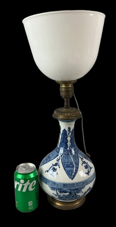 Chinese Art Deco Porcelain Table Lamp: Art Deco table lamp with Chinese blue and white porcelain base and milk glass shade. Measures 20"h x 8?dia. Condition: Untested. Some patina and scratches.