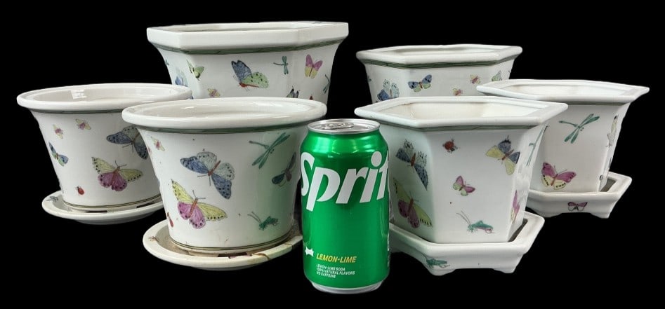Group of Asian Style Porcelain Butterfly Planters: Grouping of 6 Asian style porcelain planters with butterfly designs and under plates. Largest planter measures 7"h x 9.5"w. Condition: All pieces have some surface wear, scratches, small chips. One