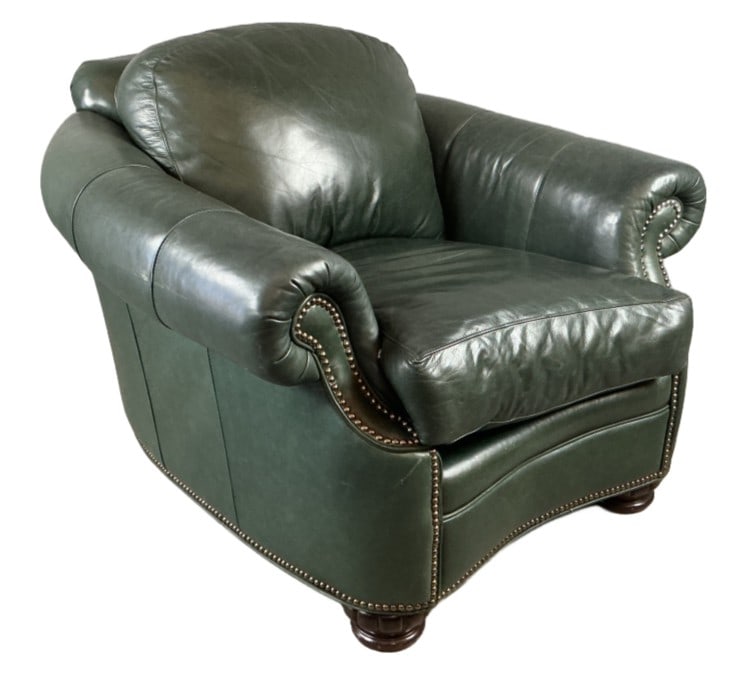 Bradington Young Green Leather Armchair: Bradington Young green leather armchair with nailhead trim. Measures 32"h x 39.5"w x 43"d. Condition: One torn seam, scratches and scuffs.