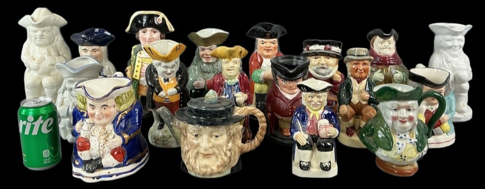 Large Grouping of Toby Jugs & Other Articles: Large grouping of Toby jugs and other articles. Comprised of: 18 total pieces. 15 jugs, 1 coin bank, 1 tankard, 1 teapot. Tallest piece measures 9.75"h. Condition: Some wear to all pieces, scratches, 