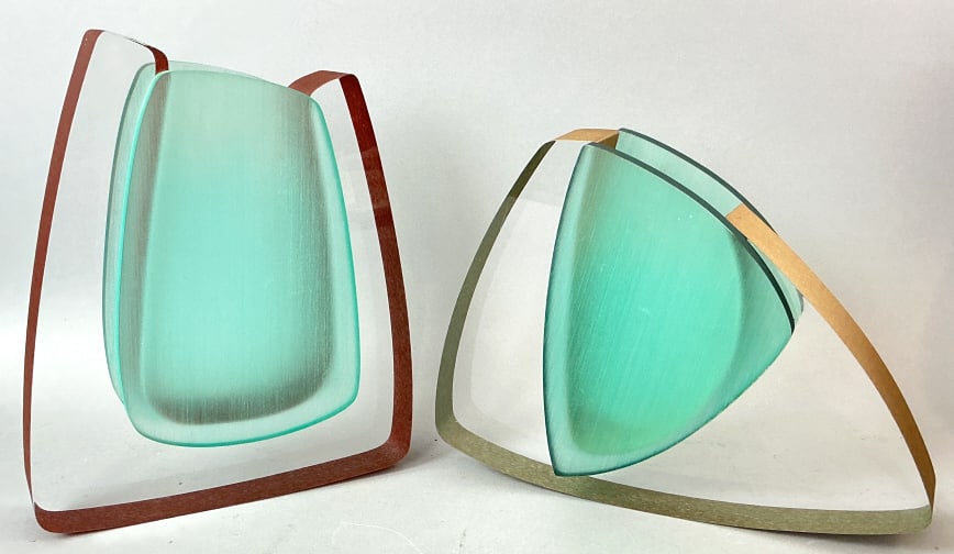 Pair of Cec LePage Lucite Sculpture Vases: Pair of Cec LePage lucite sculpture vases. Signed and dated 1999 and 2000. Clear, turquoise, gold, and red toned. Taller measures 11.25"h x 9.5"w x 2.75"d. Condition: Some scratches.