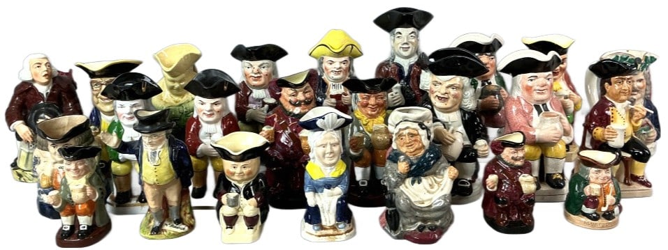 Large Grouping of Toby & Other Jugs: Large grouping of Toby and other jugs. Comprised of 24 total pieces. Largest measures 11.5"h x 5"w. Condition: Some surface wear to all pieces. Scratches, small chips, crazing, and hairlines.