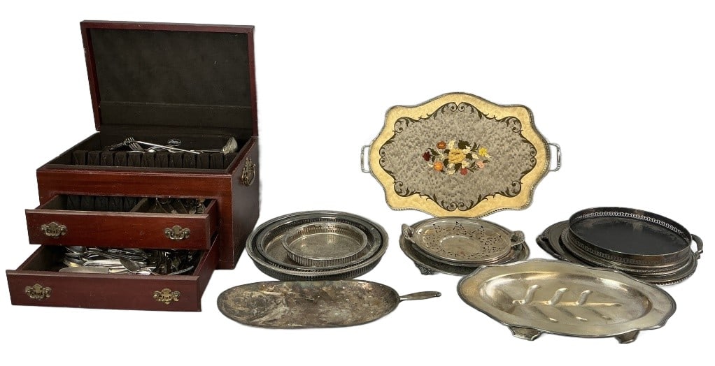Large Grouping of Silver Plate Platters & Cutlery: Large grouping of silver plated platters and cutlery. Comprised of: Over 50 pieces assorted cutlery, knives, forks, spoons, serving pieces. 1 silverware chest. 15 platters, trays, and trivet. Largest 
