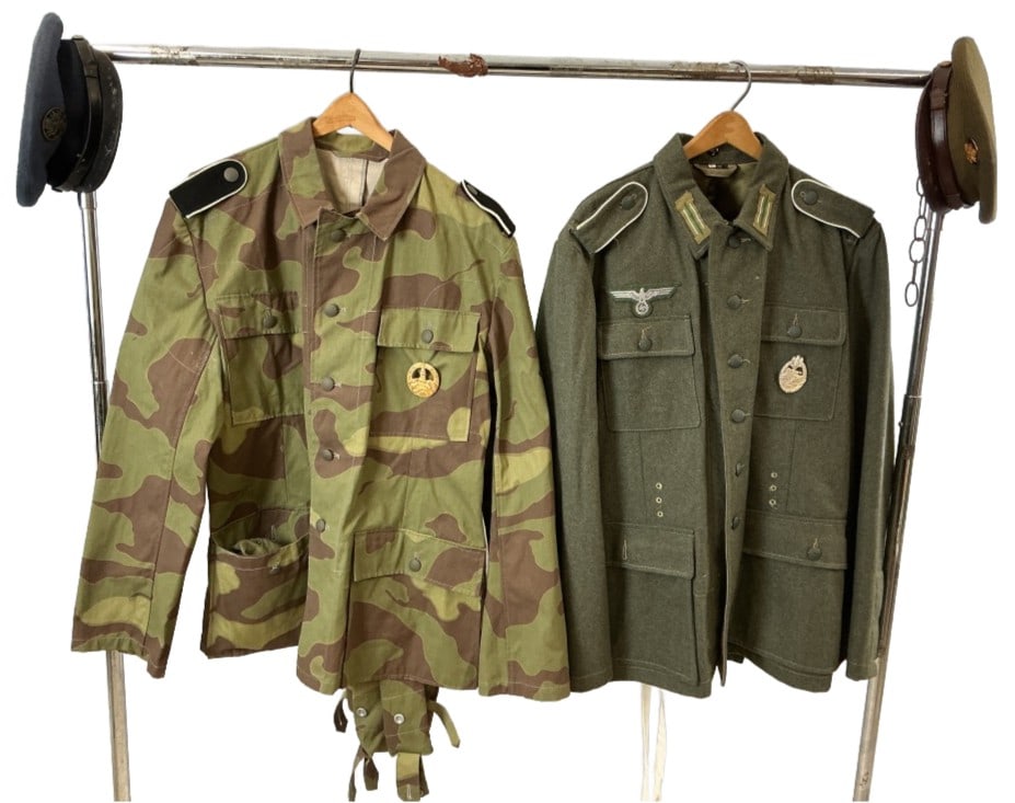 Group US Military Caps & German Repro Uniforms: Grouping of US military caps and German reproduction uniforms. Comprised of: 2 German reproduction World War II era military tunics. 2 US military service caps, one World War II era "crusher" and one 