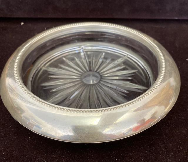 Sterling Champagne / Wine bottle coaster Whiting 1910: Sterling Champagne or Wine Bottle coaster. Starburst glass design on the bottom. Coaster measures 7" with a 5" opening for bottle. Stamped sterling, by Frank M. Whiting and Co. See coasters in next lo