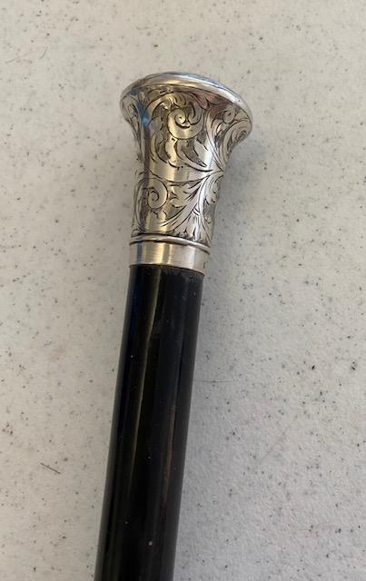 English Wood Cane with Sterling Engraved Head: Wood walking cane with sterling head. Stamped 6 W.N. and then an anchor, lion and a W. Measures 35 inches. Sterling head/grip measures 2" tall. 30.00 DOMESTIC SHIPPING W/INSURANCE.