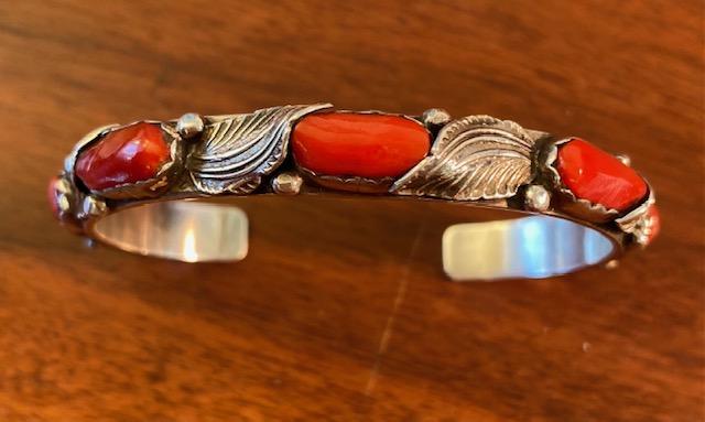 Native American Sterling & Coral Bracelet: Zuni sterling stamped, signed "Simplicio" bracelet with coral stones. .7 ounces, 2.25" diameter, 1" cuff opening, .25" width. FREE DOMESTIC SHIPPING.