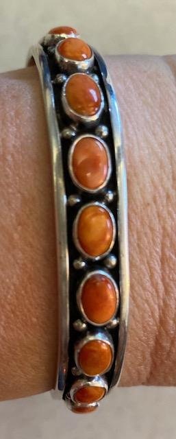Native American Spiny Oyster Signed Bracelet: Navajo sterling stamped, signed "N" Orange Spiny Oyster Bracelet. .6 ounces, 2.25" diameter, 1" cuff opening, .25" width. FREE DOMESTIC SHIPPING.
