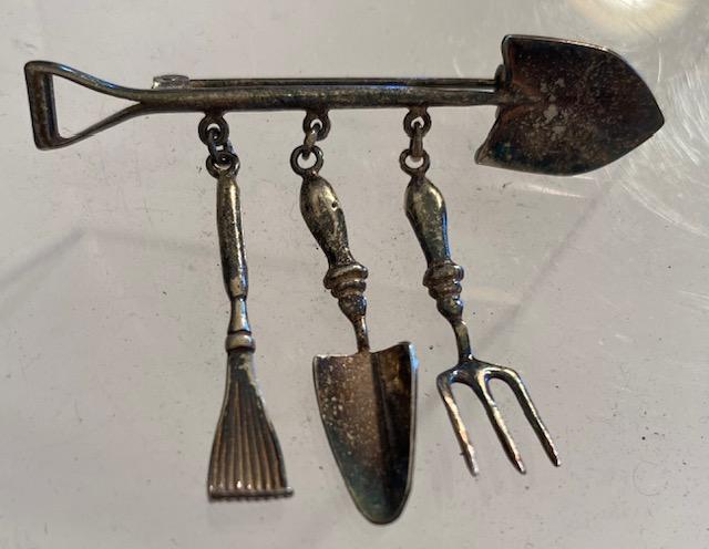 Sterling Silver Gardener's Pin: Sterling gardener's pin with gardener's tool dangles. Measures 2.5" long with 1.75" dangles. Weighs 7.3 grams. $5 DOMESTIC SHIPPING.