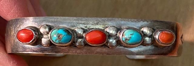 Native American Navajo Turquoise And Coral Bracelet: Native American turquoise and coral cuff bracelet with stamped design. Cuff opening measures 1". Domestic shipping $6