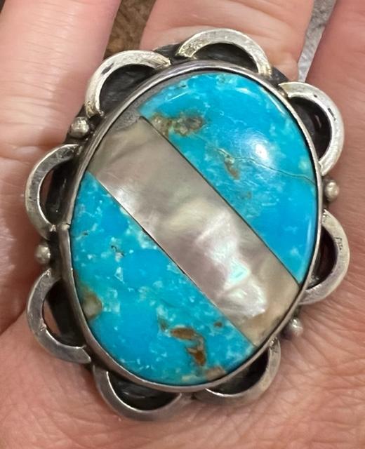 Native American Large Turquoise Ring with Mother of Pearl: Set in unmarked sterling, this is a unique ring with turquoise split with a band of mother of pearl. 1.5" x1.25" Ring size is approximately 7. Domestic shipping $6