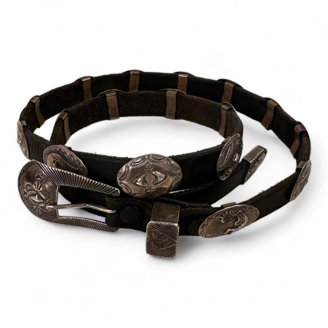 Jerry Werito Signed Buffalo, Kokopelli, Arrowhead, Bear Concho Belt: Jerry Werito signed conchos on leather belt. Various designs including buffalo, Kokopelli, arrowhead and bear effigy. Measures 35" long. See photos for details. Domestic shipping $20. USPS shipping co