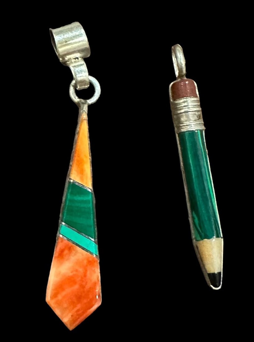 Lot of Two Signed Native American Pendants: Lot of 2 Native American signed pendants. One is shaped as a pencil and signed Poblano and made of malachite and spiny oyster. Measures 1.5". The other is signed YZ and is made of malachite and turquo