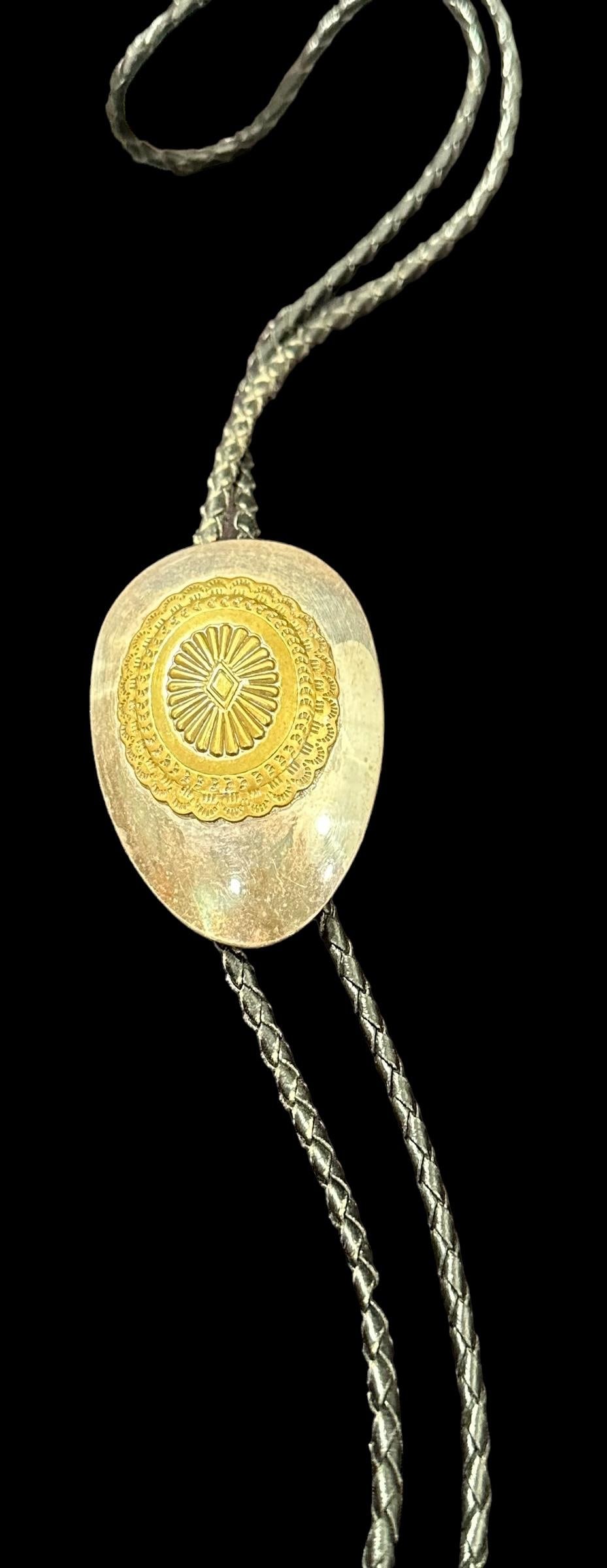 Bolo Tie/Belt Buckle Sterling Two-in-One Piece: Unmarked sterling bolo tie that could be converted to a belt buckle. Bolo has brass accents and measures 3" x 2". Domestic shipping $12. USPS shipping cost only, no additional fees for in-house materi