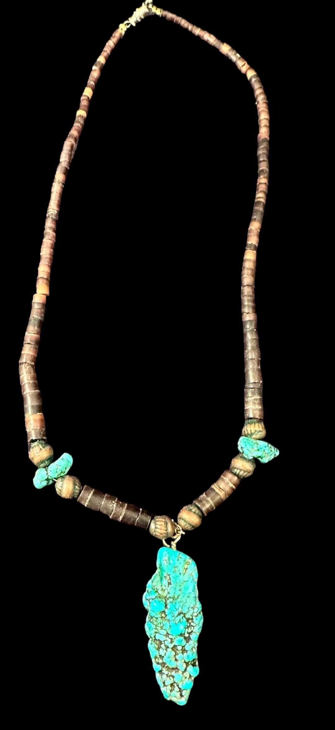 Native American Turquoise chunk and Shell Necklace: Shells strung on wire with turquoise pendant. Pendant measures 2.5". Necklace measures 17". Domestic shipping $12. No additional fees for in-house materials or handling. International shipping calcula