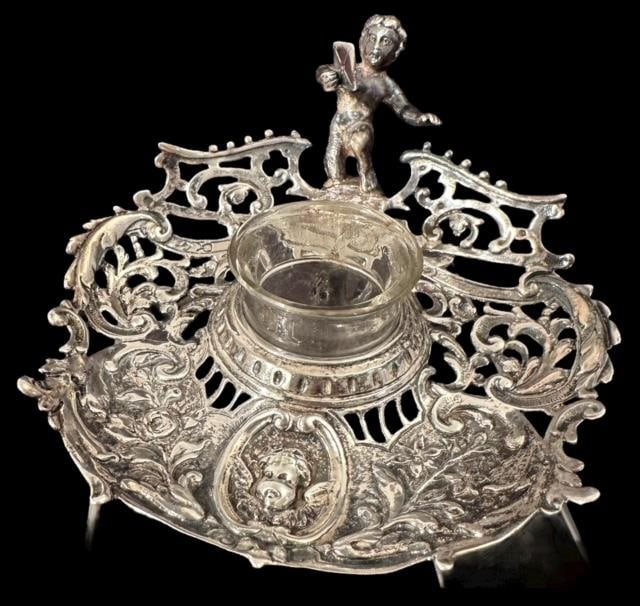 Continental Sterling Cherub Inkwell: Continental sterling cherub figure inkwell. Stamped with makers mark of a spade and chalice. See photos. Unmarked sterling. Measures 2.25" x 4". Domestic shipping $10.