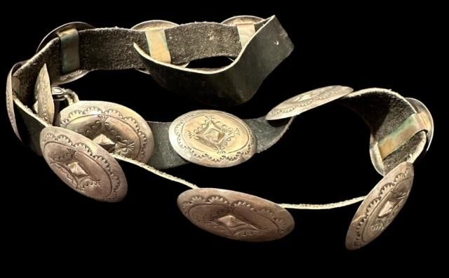 Native American 11 Conchos and One Buckle Sterling Belt on Leather: Native American concho belt. Eleven conchos plus buckle. Measures 34". All stamped with the same design. Conchos and buckle measure 2" x 1.5". Unmarked. Domestic shipping $16.