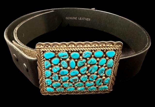 Native American Signed Verdy Jake Sterling and Kingman Mine Turquoise Belt: Native American sterling and turquoise belt. Belt Buckle signed V for Verdy Jake. Turquoise stones from Kingman mine. Buckle measures 3" x 2.5". Belt is marked 28" and measures 34" with buckle. Domest