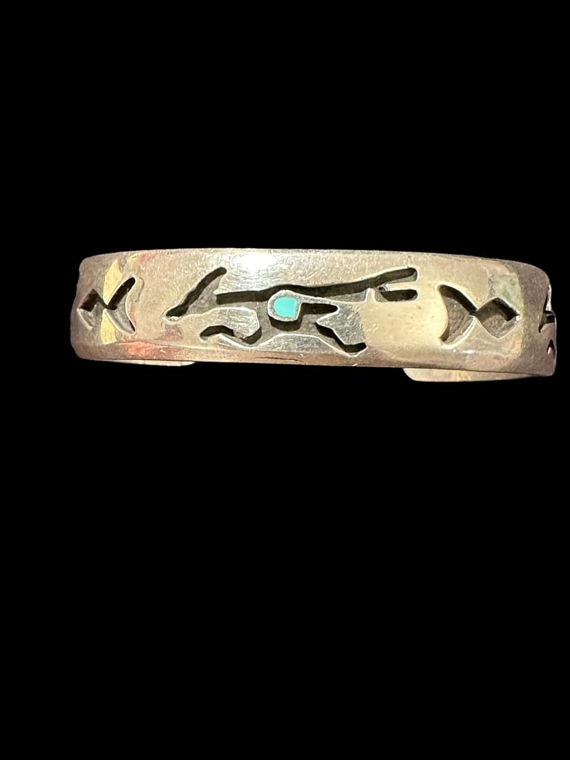 Native American Sterling and Turquoise Cuff Bracelet: Native American sterling (tested, unmarked) cuff bracelet with turquoise Roadrunner design inlay. Circumference measures 6.5" with a 1.25" cuff opening. Unsigned. Domestic shipping $6.