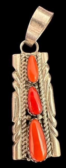 Native American Navajo Signed V. Quam Sterling and Coral Pendant: Native American Navajo sterling (tested, unmarked) coral pendant. Signed V Quam. Measures 2" x .5". Domestic shipping $8.