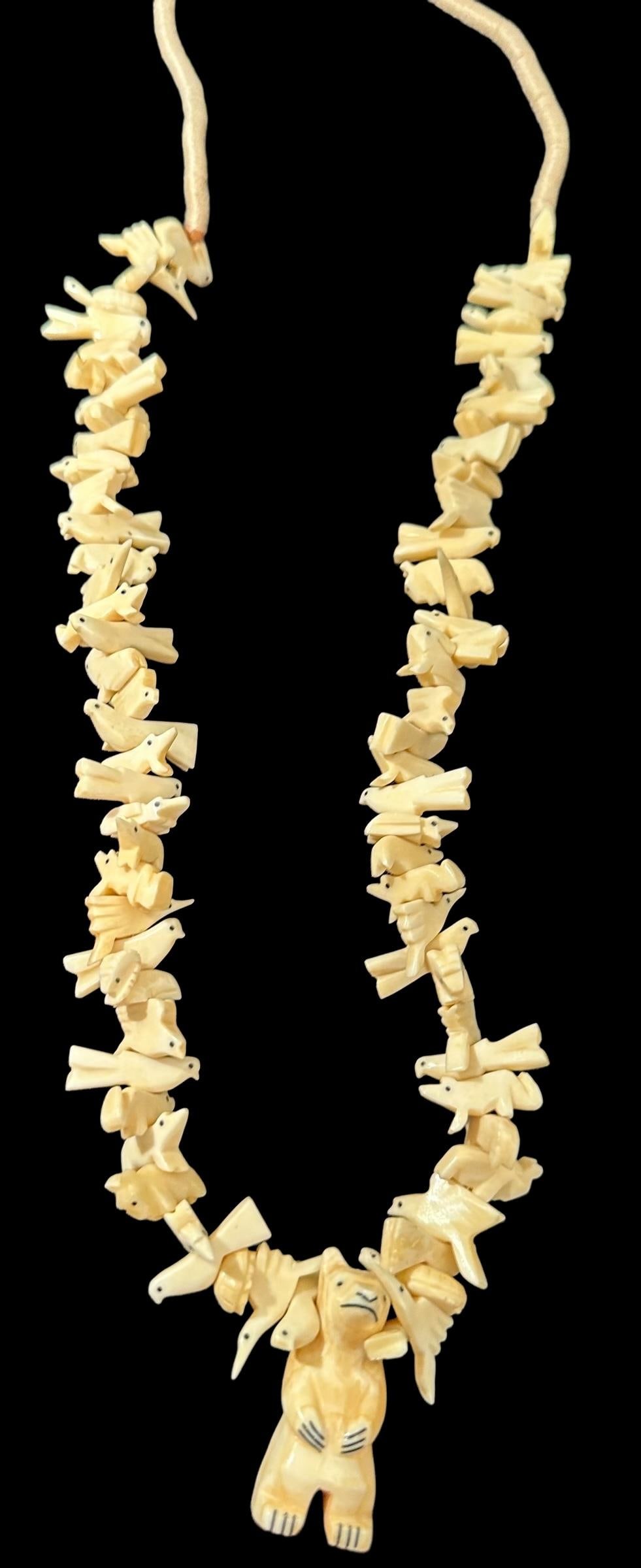 Native American Zuni Carved Bone Fetish Necklace: Native American carved fetish necklace with various fetishes and a bear pendant. Strung on a cord and measures 30". Bear measures 2". Domestic shipping $16.