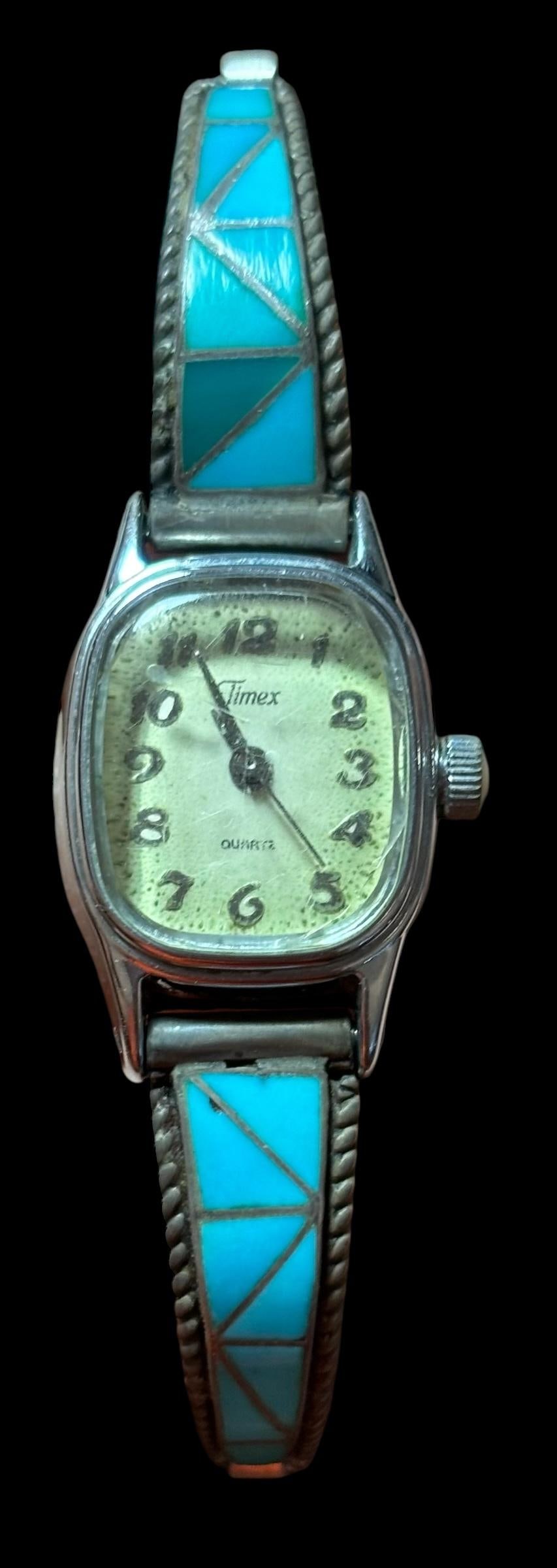 Native American Sterling and Turquoise Watch Band: Native American sterling (tested, unmarked) and turquoise watch band. Timex watch face needs a battery. Band is approximately .25" wide and tapers down. Un-expandable band. Domestic shipping $10.