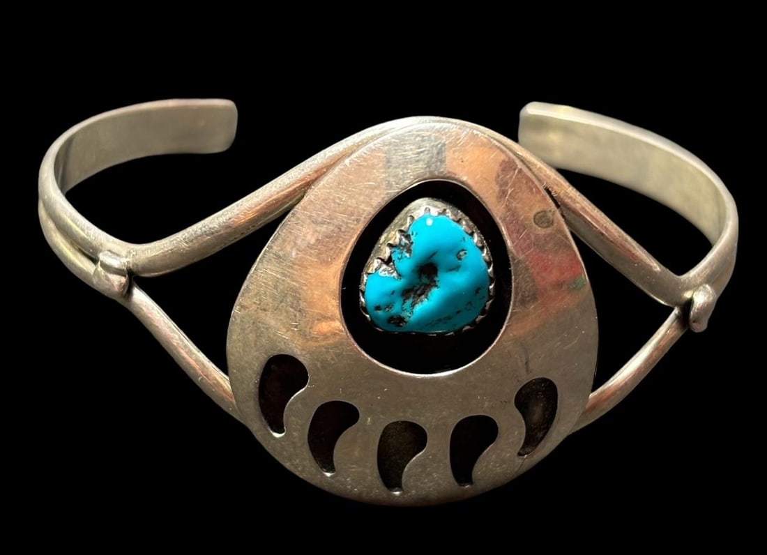 Native American Bracelet with Turquoise: Native American bracelet. Bear claw design with turquoise accent. Unmarked. 1.25" opening. Domestic shipping $8.