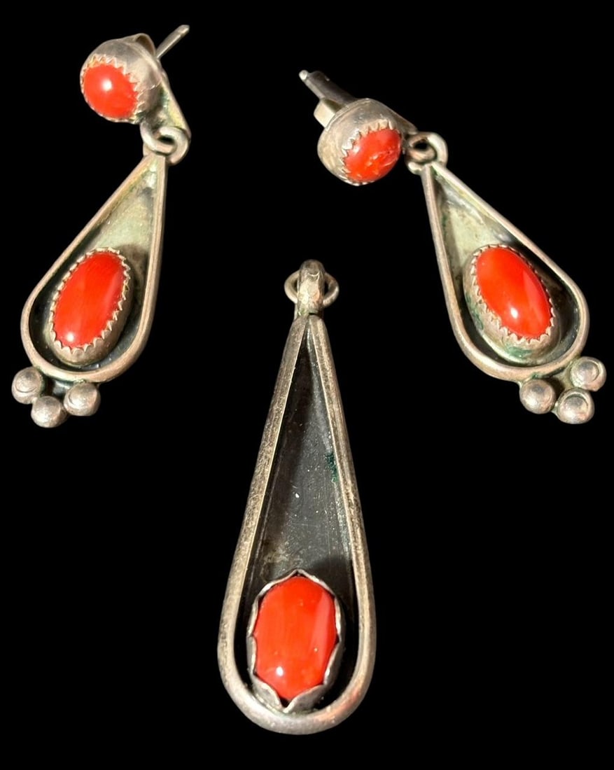 Signed MP Navajo Sterling and Coral Earrings and Pendant Set: Native American Navajo sterling and coral earring and pendant set. Earrings signed with a stylized MP. Pendant is unsigned. Measures 1.5". Domestic shipping $10.